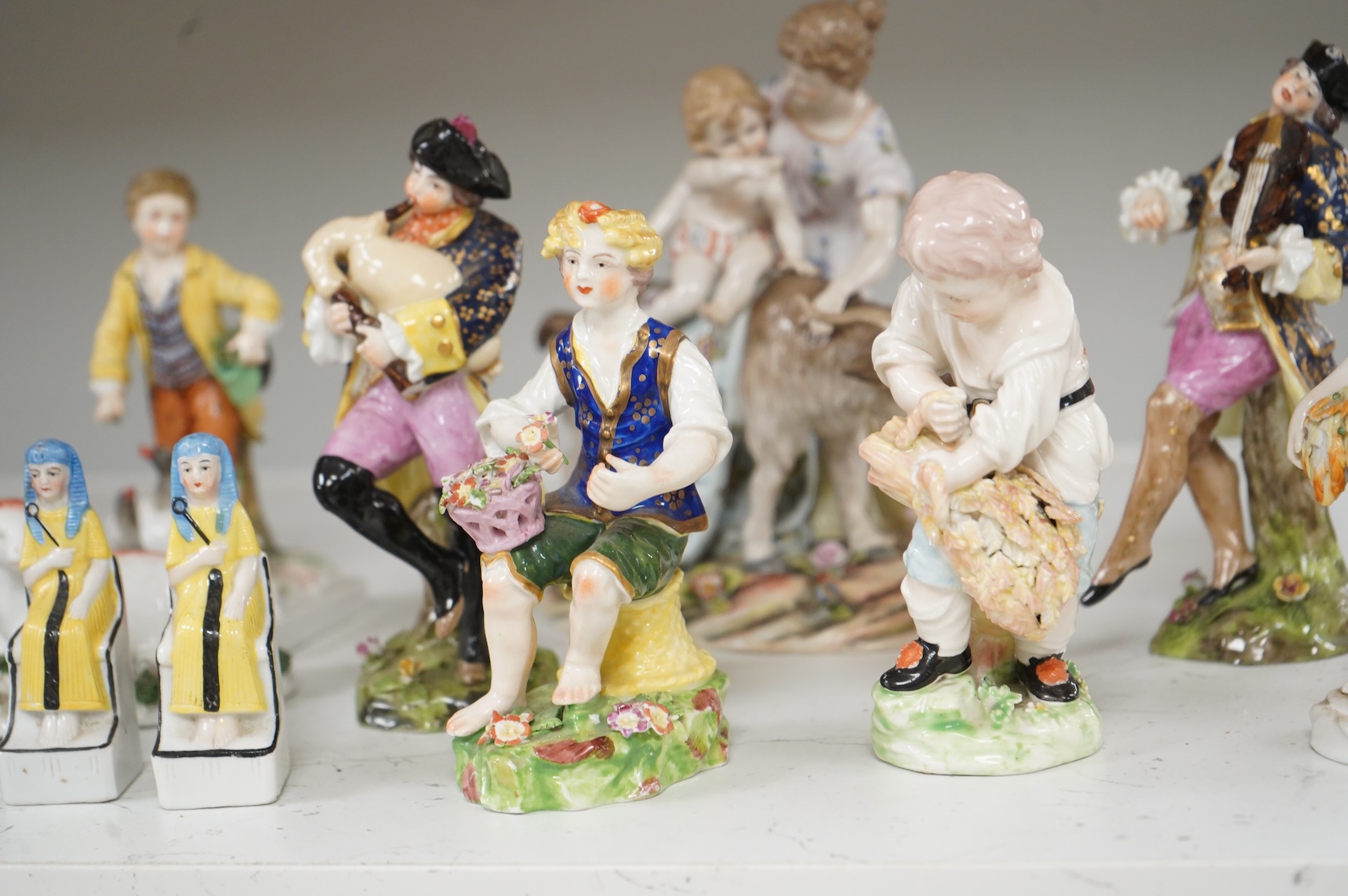 Two Derby porcelain seated figures emblematic of summer and autumn and a collection of Continental porcelain figures to include a pair of recumbent cows, largest 18cm high